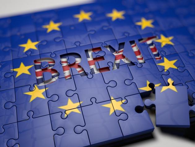 EU flag puzzle with 'Brexit' written across the middle and one piece of puzzle being removed